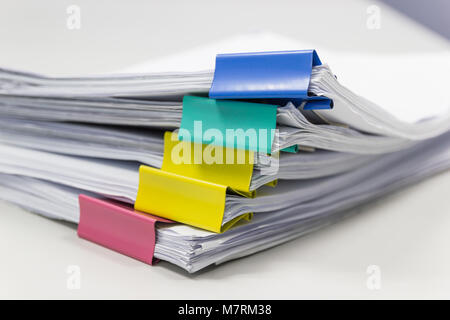 Stack of papers documents in archives files with paper clips on desk at offices, business concept. Stock Photo