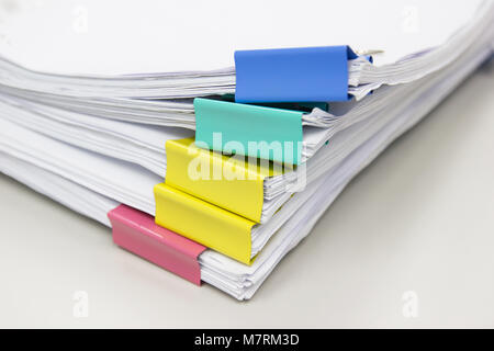 Stack of papers documents in archives files with paper clips on desk at offices, business concept. Stock Photo