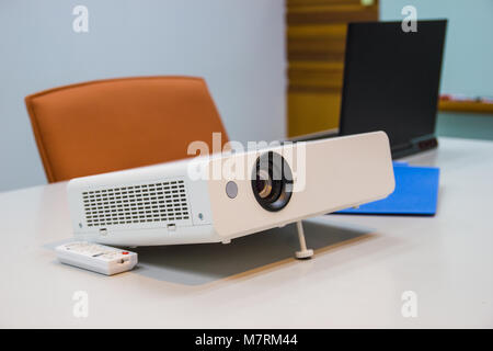 projector connected to Laptop on for  presentation in a meeting room, business concept. Stock Photo