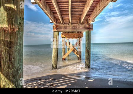 Boardwalk across the White sand beach and aqua blue water of Clam Pass in Naples, Florida in the morning. Stock Photo