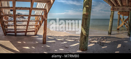 Boardwalk across the White sand beach and aqua blue water of Clam Pass in Naples, Florida in the morning. Stock Photo