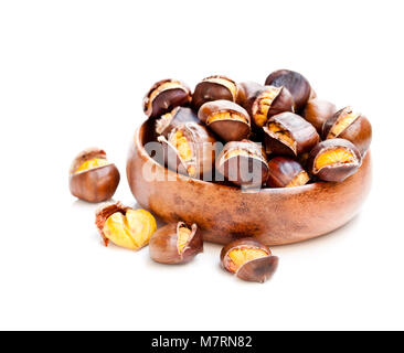 Roasted  sweet chestnuts in wooden bowl isolated on white Stock Photo