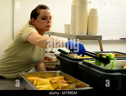 U.S. Air Force Staff Sgt. Dawn Spence, 455th Expeditionary Medical Support Squadron nutritional medicine diet technician prepares meal trays for patients May 13 at Bagram Airfield, Afghanistan.  As part of nutritional medicine, Spence provides nutritional care and quality foodservice while promoting military readiness and community wellness.  Spence is deployed from Lackland Air Force Base, Texas and a native of Paradise, Calif. (U.S. Air Force photo by Staff Sgt. Evelyn Chavez/Released) 455th Air Expeditionary Wing Bagram Airfield, Afghanistan Stock Photo