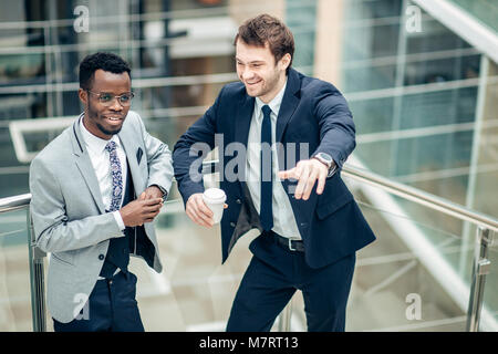 Two multiethnic male employees consulting in office Stock Photo