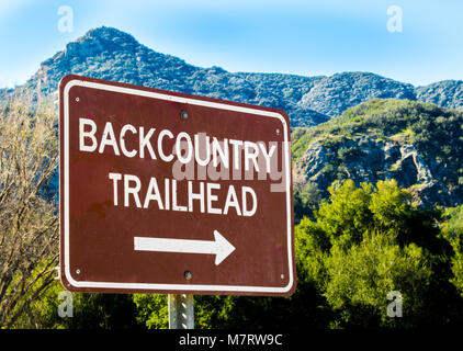 brown and white sign pointing to 'Back country Trail head' in the lush Santa Monica Mountains of California, USA Stock Photo