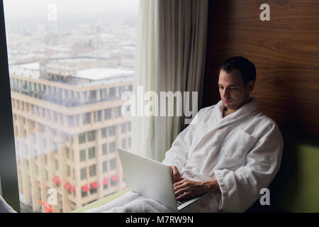 Young man freelancer working from home on a laptop Stock Photo