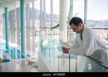Happy guy communicating on telephone in luxury spa hotel Stock Photo