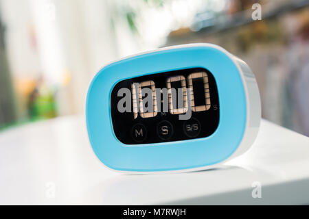 10 Minutes - Macro Of An Digital Blue Kitchen Timer On White Table Stock Photo