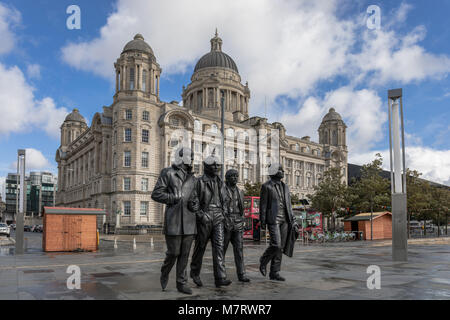 The Beatles Statue in Liverpool with the Port of Liverpool building in the background - Liverpool, Merseyside, UK Stock Photo