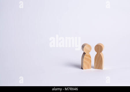 wooden human figures stand together. Social concept, family, team, friends, brothers and sisters. Space for text. Stock Photo