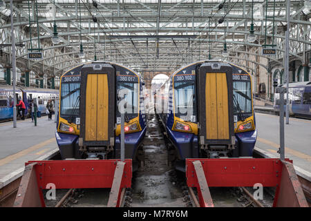 2 Siemens Class 380 Electric Trains side by side at Platforms 12 and 13 of Glasgow Central Train Station