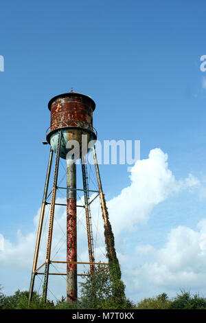 Old rusty water tower against the blue sky Stock Photo - Alamy