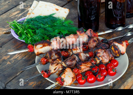 juicy fried tasty shish kebab with vegetables on skewers close-up Stock Photo