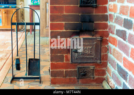 view of the stove and accessories close-up in a wooden country house close-up Stock Photo
