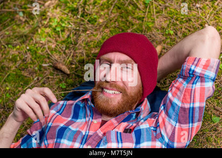 happy forester on vacation in forest, man in hat with beard Stock Photo