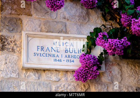 SPLIT, CROATIA, September 15, 2016 -  Beautiful croatian number plate of the road with bougainvillea flower on the street Frane Bulic near Diocletian  Stock Photo