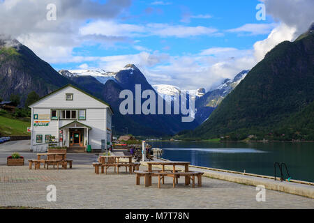 Local grocery store in Mundal, Fjaerland with picnic area by the Fjaerland fjord surrounded by Majestic mountains and the Jostedal glacier Stock Photo