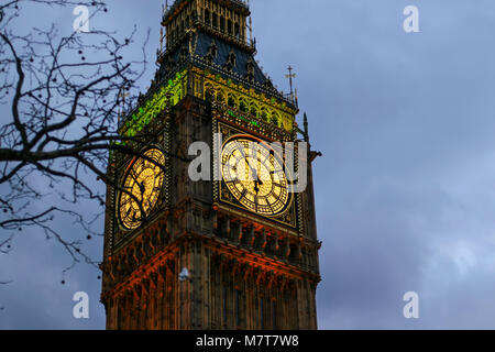 Detail of clock on Big Ben in London, United Kingdom illuminated by lights in evening Stock Photo