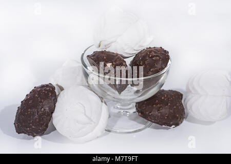 Black and white marshmallows in glassware. Abstract photo of the chocolate industry. Stock Photo