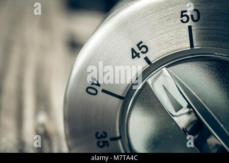 45 Minutes - Three-Quartes Of An Hour - Macro Of An Analog Chrome Kitchen Timer On Wooden Table Stock Photo