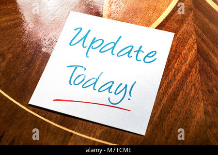 Update Sticky Note For Today On Paper Lying On Wooden Cupboard Stock Photo