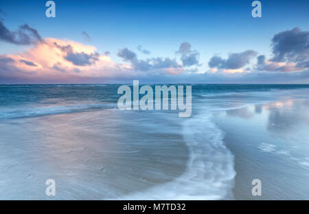 blurred wave on north sea coast at sunrise Stock Photo
