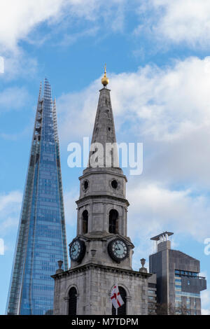 An unusual or different angle viewpoint of the shard office building in central london next to an old church in borough high street. Architectural. Stock Photo