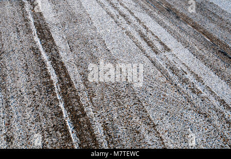 Section of a frosty road surface with a dusting of snow on a chilly February morning. Stock Photo