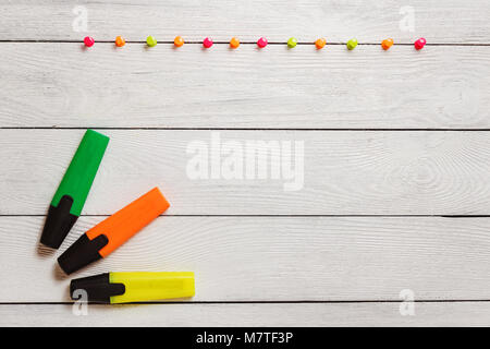 Yellow, Green, Orange Highlighter, Colorful Pushpins on White Wooden Table, Stationary, Copy Space. School Concept. Stock Photo