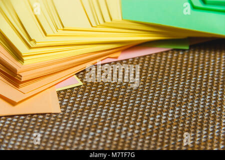 Stationary, Stack of Blank Colored Sticker on Brown Board. Time-management, Planning. Stock Photo