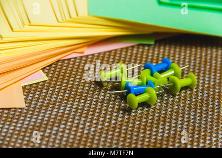 Stationary, Pushpins Heap, Blank Colored Sticker on Brown Board. Time-management, Planning. Stock Photo