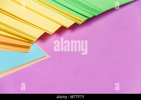 Stationary, Stack of Blank Colored Sticker on Lilac Board. Time-management, Planning. Stock Photo