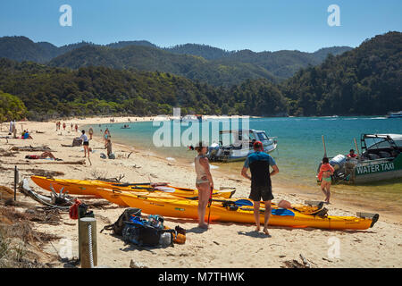 Kayaks and water taxis at Anchorage Beach, Abel Tasman National Park, Nelson Region, South Island, New Zealand