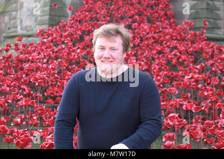 Hereford Cathedral, Hereford - Tuesday 13th March 2018 - Artist Paul Cummins in front of his poppy sculpture Weeping Window at Hereford Cathedral as part of the final year of the 14-18 NOW First World War centenary art project. Almost 6,000 individual ceramic poppies flow from an upper window down to the ground. The exhibit will be at Hereford Cathedral until 29th April 2018. Photo Steven May / Alamy Live News Stock Photo