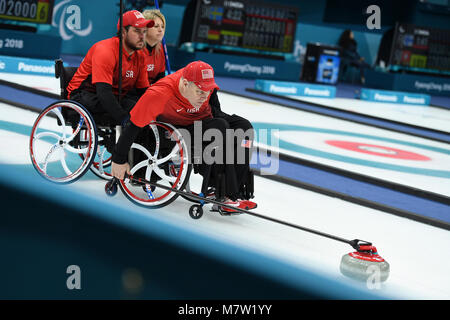 PyeongChang, South Korea. 13th March, 2018. Kirk Black (R) from the United States competes during the match between the United States and China at the mixed round robin session 10 of wheelchair curling at the 2018 PyeongChang Winter Paralympic Games at PyeongChang, South Korea, March 13, 2018. (Xinhua/Xia Yifang) Credit: Xinhua/Alamy Live News Stock Photo