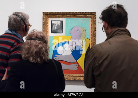 London, UK.  13 March 2018.  Members of the public view 'Woman in a Yellow Armchair (Femme dans un fauteuil jaune)', 1932, by Pablo Picasso, on display at 'Picasso 1932 - Love, Fame, Tragedy', the Tate Modern's first ever solo exhibition of the work of Pablo Picasso.   More than 100 paintings, sculptures and works on paper covering the year 1932, a pivotal time in Picasso's life, are on display 8 March to 9 September 2018, in one of the year's most popular shows at Tate Modern.  Credit: Stephen Chung / Alamy Live News Stock Photo