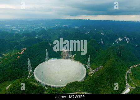 (180313) -- GUIYANG, March 13, 2018 (Xinhua) -- File photo taken on Aug. 9, 2017, shows the Five-hundred-meter Aperture Spherical Radio Telescope (FAST) in Pingtang County, southwest China's Guizhou Province. China's FAST, the world's largest single-dish radio telescope, has discovered 11 new pulsars so far, the National Astronomical Observatories of China (NAOC) said Tuesday. (Xinhua/Ou Dongqu)(wsw) Stock Photo