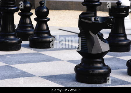 Chess pieces on an outside chess board Stock Photo