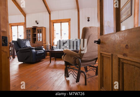 Living room inside the extension of an old Canadiana cottage style fieldstone residential home. Stock Photo