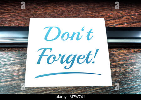 Don't Forget Reminder On Paper Lying On Wooden Table Stock Photo