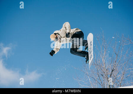 Snowboarder jumping on halfpipe Stock Photo