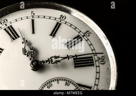 Monochromatic close-up on a old watch with clipped black background Stock Photo