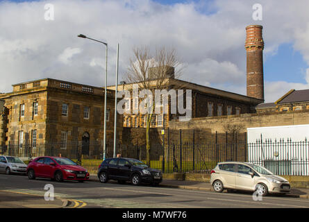 Belfast Northern Ireland the historic Crumlin Road Jail now used as a modern museum and visitors centre with its large chimney stack dominating the la