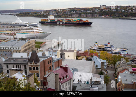 Quebec, Canada.  Ships on the St. Lawrence River.  Crystal Serenity Cruise Ship on left, Container Cargo Ship in Mid-river. Stock Photo