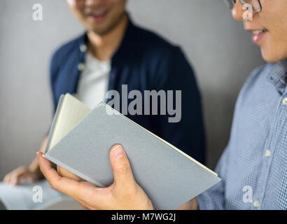 Group study, two men open book and take notes Stock Photo