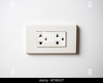 White socket 220 volts on white wall, unplugged Stock Photo
