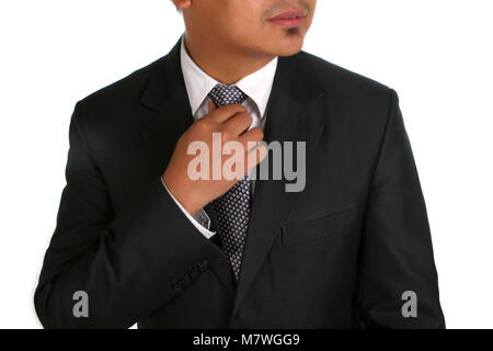 Business man adjusting his tie, cropped so face is not visable. Stock Photo