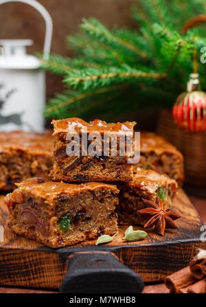 Fruitcake with raisins, dates, candied citrus, honey, cinnamon, anise and cardamom. Homemade Christmas dessert.  New year. Selective focus Stock Photo