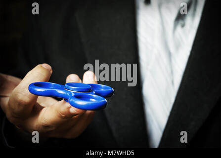 A man holding a blue spinner. Stock Photo