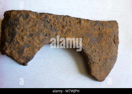 Photo depicts iron rusty but very sharp old wooden ax blade, placed on a timber with chopping trace. Axeman equipment tool concept. Ax and ax handle,  Stock Photo